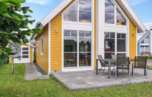 una casa gialla e bianca con tavolo e sedie di Sonnenblick a Wandlitz