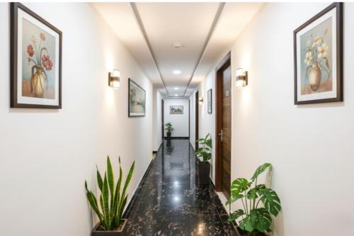 a hallway with plants on the walls at FabHotel New Silver Crown in New Delhi