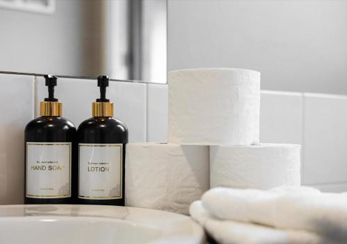 two bottles of wine sitting on top of a sink at LUXURY 3-Bed Home Perfect for Families & Groups in Sebastopol