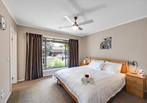 a bedroom with a bed with two towels on it at LUXURY 3-Bed Home Perfect for Families & Groups in Sebastopol