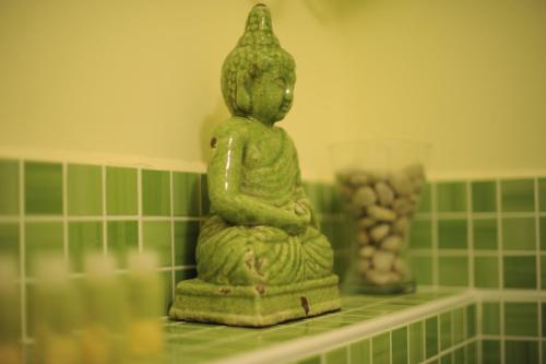 a statue sitting on a shelf in a bathroom at Apartments Life & Energy in Čatež ob Savi