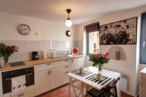 une cuisine avec une table et une horloge au mur dans l'établissement Studio Panier 1970, à Marseille