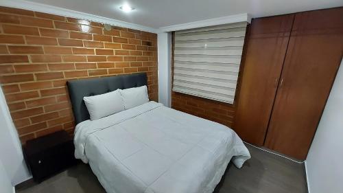 Una cama o camas en una habitación de Apartamento para descansar 2