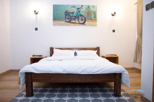 a bedroom with a bed with a motorcycle on the wall at Andu Kuboiye Homes in Kimana