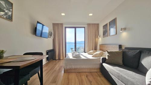 a living room with a couch and a table at GVC New Gudauri Loft-2 in Gudauri