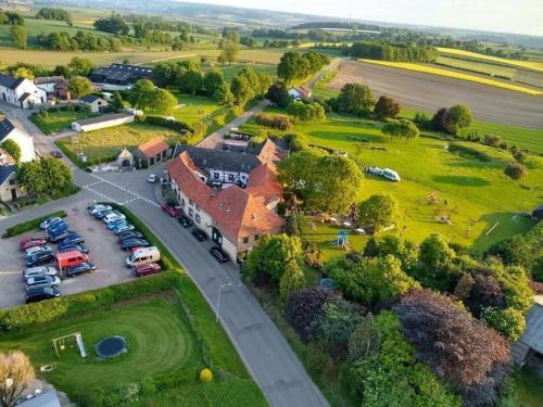 an aerial view of a village with a parking lot at Valley view cottage vlakbij Valkenburg in Voerendaal