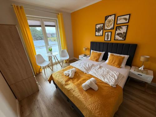 Ένα ή περισσότερα κρεβάτια σε δωμάτιο στο BALTICUS Mrzeżyno