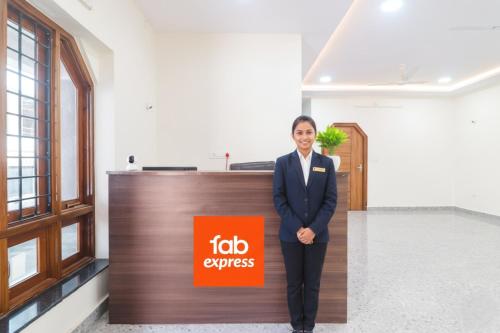 a man in a suit standing in front of a job express sign at Via RS Living - Nr TCS Deccan Park, Hitech City in Hyderabad