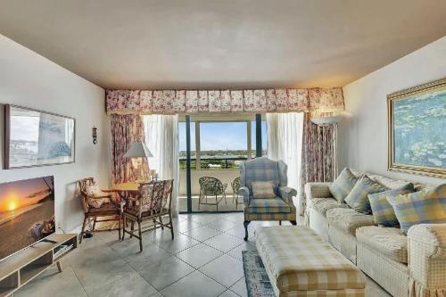 een woonkamer met een bank en een tafel bij Luxury Two-Bedroom Oceanfront Apartment With Panoramic Views in South Palm Beach
