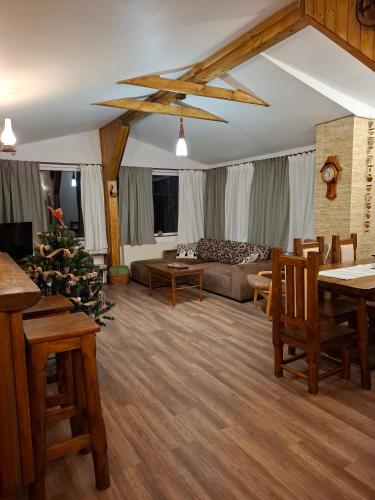 a living room with a couch and a christmas tree at Casa Zaharia Azuga in Azuga