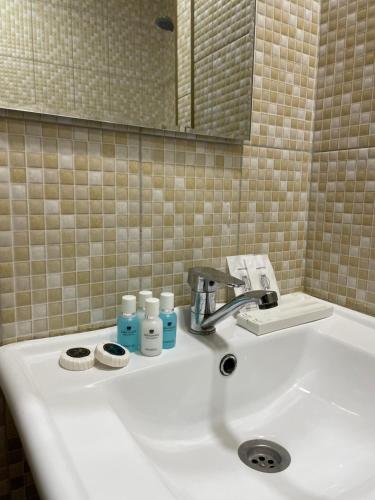 バクーにあるBest Center Nizami Hotelのバスルーム(洗面台、バスアメニティ、鏡付)