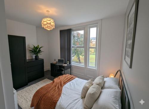 a bedroom with a bed and a window at Summerhill Sunderland Business Stay 6 Private Ensuite Rooms in Sunderland