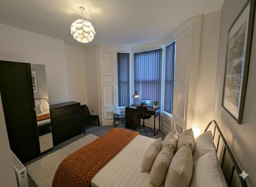 a bedroom with a bed and a desk and a window at Summerhill Sunderland Business Stay 6 Private Ensuite Rooms in Sunderland
