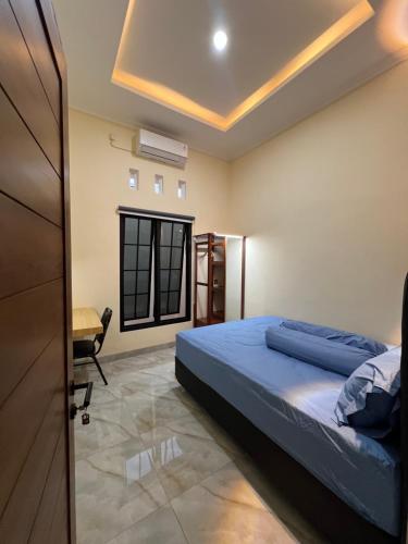 a bedroom with a bed and a desk at Tentrem Madani in Yogyakarta