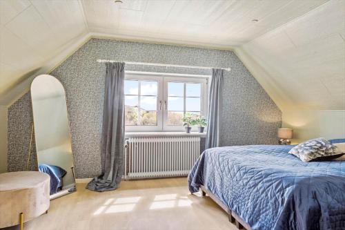 a bedroom with a bed and a window at 193-Vestervig-Vesterhavsvej-36 in Vestervig