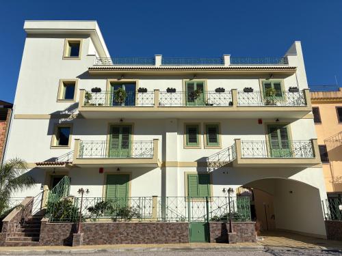 a large white building with balconies on it at La Casa di Zefiro in Santa Flavia