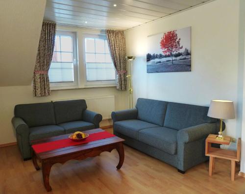 a living room with two couches and a coffee table at Landhaus Bolzum in Sehnde
