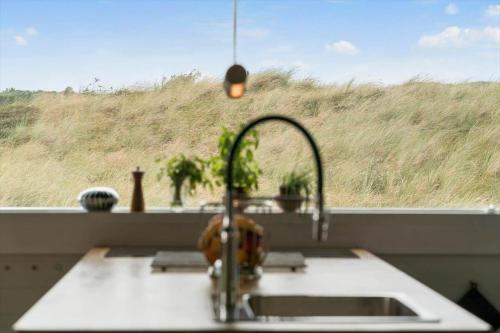 a sink in a kitchen with a view of a window at 302-Snedsted-Klitfogedvej-7 in Snedsted