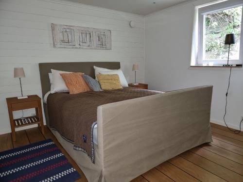 a bedroom with a large bed in a room at Modern Cottage with Sea View in Svanesund SE09151 in Svanesund