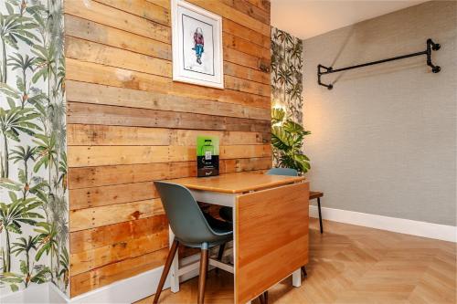 a wooden accent wall in a room with a desk and a chair at City View Flat, Quiet Bedroom, Work Ready Desk in Bristol
