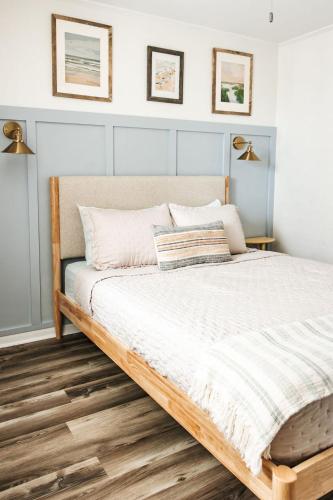 a bedroom with a large bed with white sheets at Sanderling - Pet Friendly - Walk to Beach - Pool! in Holden Beach