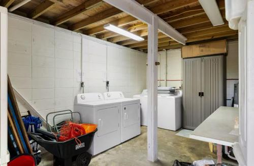 a laundry room with a washer and dryer at Sanderling - Pet Friendly - Walk to Beach - Pool! in Holden Beach