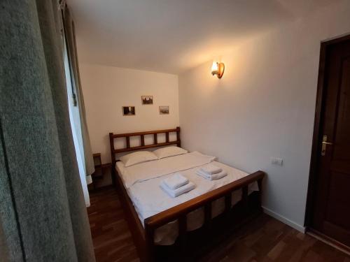 a bedroom with a bed with two towels on it at Casa Zaharia Azuga in Azuga