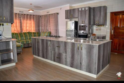 a kitchen with a large island in a living room at Tranquil villa in Kitale