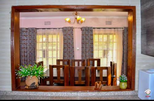 a mirror in a room with a dining room at Tranquil villa in Kitale