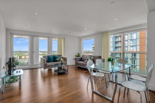 a living room with a table and chairs and windows at Talisman & Duckman Tower at Canary Wharf by MySquare in London