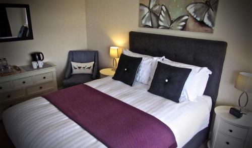 a bedroom with a large bed with two laptops on it at The Moorhead Bed & Breakfast in Wem