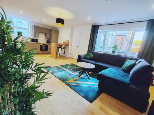 a living room with a couch and a table at Fresh Spring Getaway-Christchurch Town Centre in Christchurch