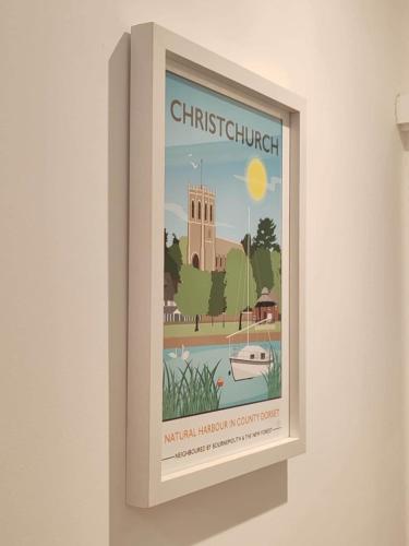 a framed picture of a christchurch sign on a wall at Fresh Spring Getaway-Christchurch Town Centre in Christchurch