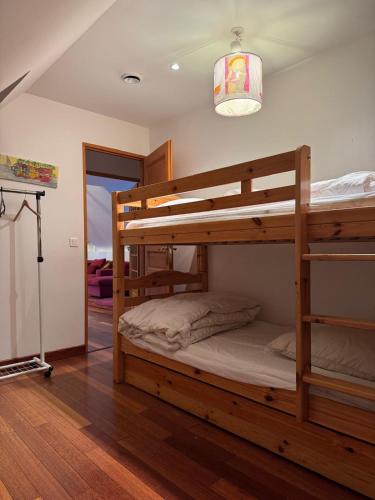 a bedroom with two bunk beds and a lamp at Grange des Taouré in Vignec