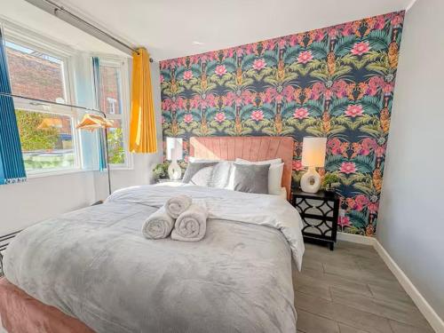 a bedroom with a large bed with towels on it at Charming 3BR in Oxford Centre in Oxford