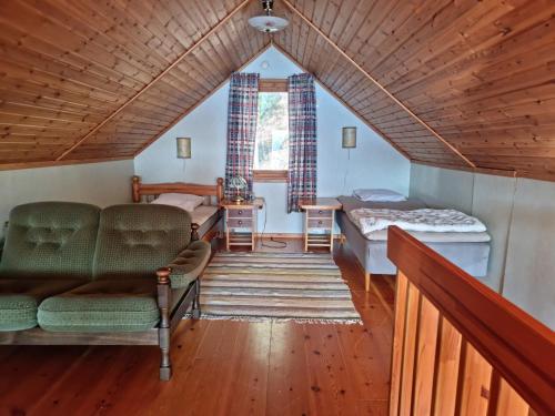 a living room with a couch and a table at Holiday home- 50m to sandy beach at Kavlanda Brygga SE09147 in Tviklippan