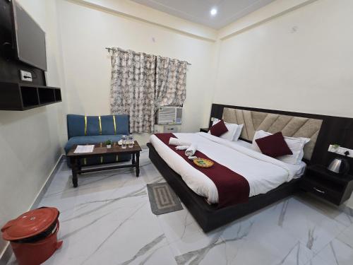 AyodhyaにあるAbhi palace Ayodhyaの大きなベッドとテーブルのある寝室