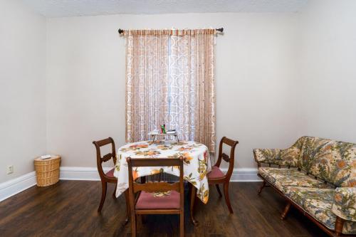 a living room with a table and a couch at Historic 4BR Home near Lynchburg Colleges in Lynchburg