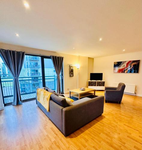 a living room with a couch and a television at Scotapartments in Edinburgh