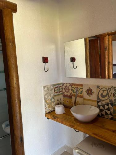 a bathroom with a sink and a mirror at Pousada Mandalla in Serra do Cipo