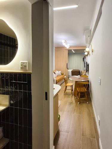 a room with a kitchen and a dining room with a table at Ipanema Charm and Luxury in Rio de Janeiro