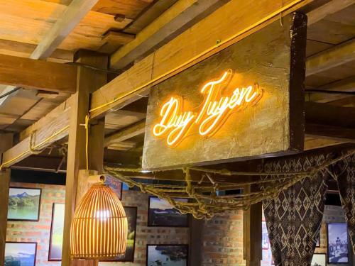 a lit up sign hanging from the ceiling of a restaurant at Duy Tuyen Ba Be Homestay in Bak Kan