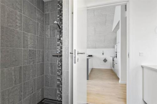 a bathroom with a walk in shower next to a hallway at 793-Thisted-Havstokken-24-1 in Thisted