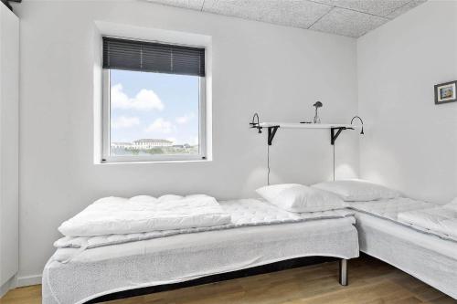 a white room with a bed and a window at 793-Thisted-Havstokken-24-1 in Thisted