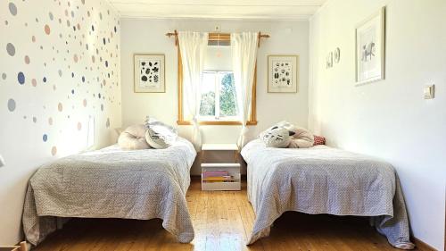 a bedroom with two beds and a window at Family-friendly house close to sea & nature in Klövedal SE09145 in Viks Ödegärde