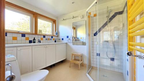 a bathroom with a shower and a toilet and a sink at Family-friendly house close to sea & nature in Klövedal SE09145 in Viks Ödegärde