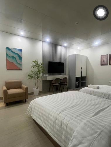 a bedroom with a large bed and a television at Khách sạn Sole'a VĨNH YÊN in Vĩnh Phúc