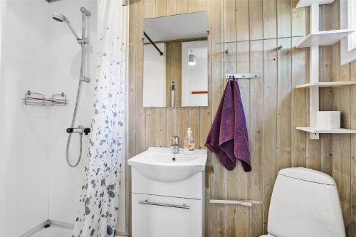 a bathroom with a sink and a toilet and a mirror at 212-Vestervig-Havnevej-1-lejl-12 in Vestervig