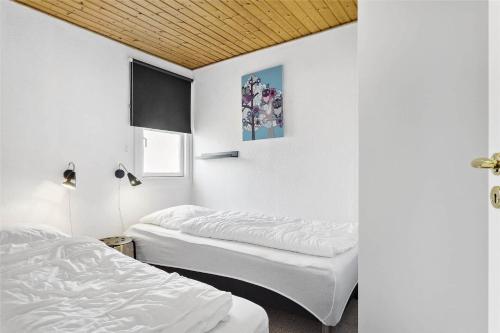 two beds in a room with white walls at 212-Vestervig-Havnevej-1-lejl-12 in Vestervig