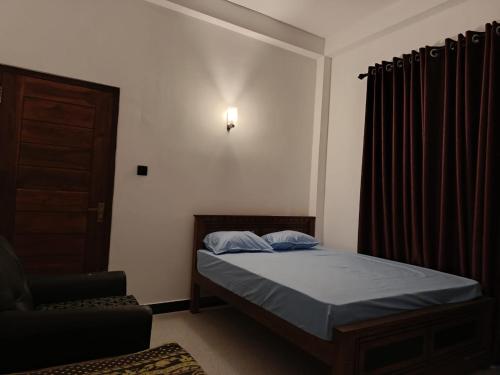 a small bedroom with a bed and a chair at Horizon Guest Hatton in Hatton